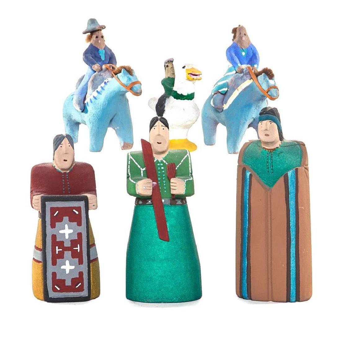 SIX NAVAJO FOLK ART FIGURES: Including three carved sandstone figures by Homer J. Warren; and three pottery examples of people riding horses or a duck, the latter signed M.D. Height 7 1/2 - 3 1/2 inches