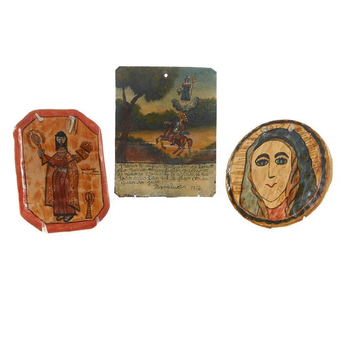THREE SOUTHWEST RETABLOS: Including two New Mexican examples on wood by Nicholas Herrera, one dated 1994; and a contemporary Mexican replica ex-voto on tin dated "1912". Length 8 1/4, 7 1/2 and 10 inches