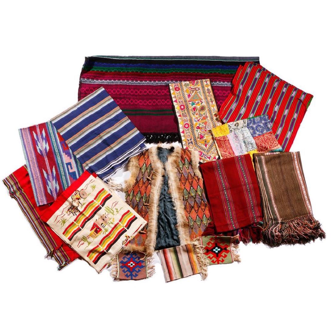 17 ETHNOGRAPHIC TEXTILES: Including an embroidered vest and a variety of decorative examples, from India, Guatemala, Mexico, and elsewhere. Length of vest 27 inches