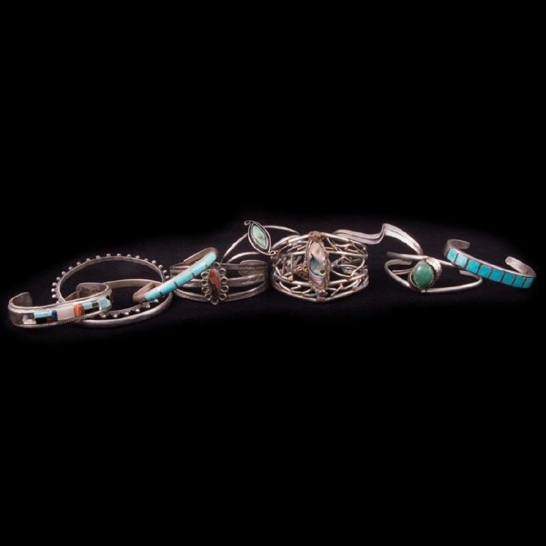 Southwest Bracelets: Southwest bracelets. A group of ten turquoise, shell and hard stone silver bracelets. Largest example is approximately: 1 3/4 inches (wide). Approximate size: 5, 6, 6 1/2 inches, which includes the ad