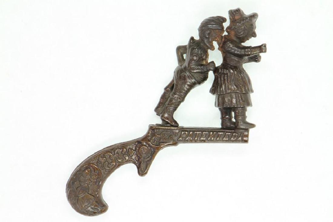 "Punch and Judy" Animated Cap Pistol: Ives, 1882; Varnished Cast Iron; Rear Figure (Punch) nose rotates Forward into Judy's Back to explode Cap; surface rust at cap impact area (should clean up ok);Excellent Condition, 5 1/4"L. Buyer pays