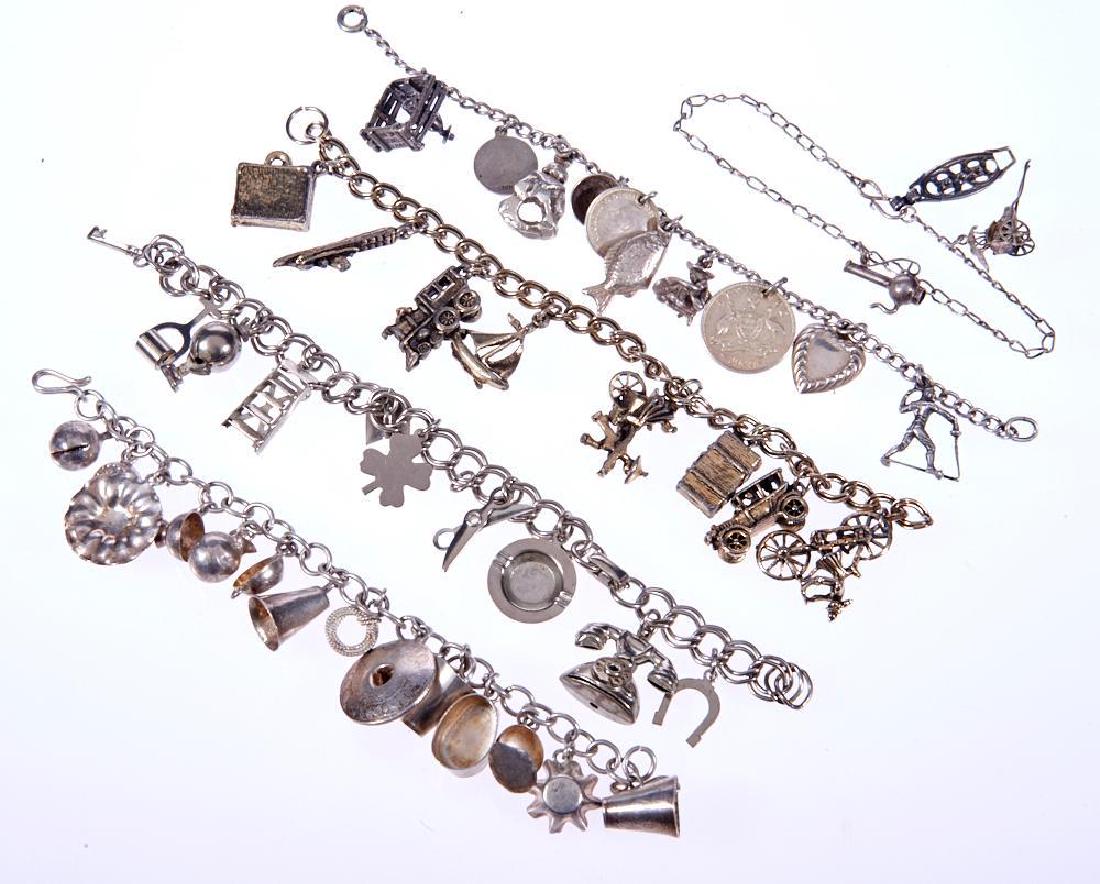 Five silver and metal charm bracelets: suspending 44 charms and including 11 loose charms