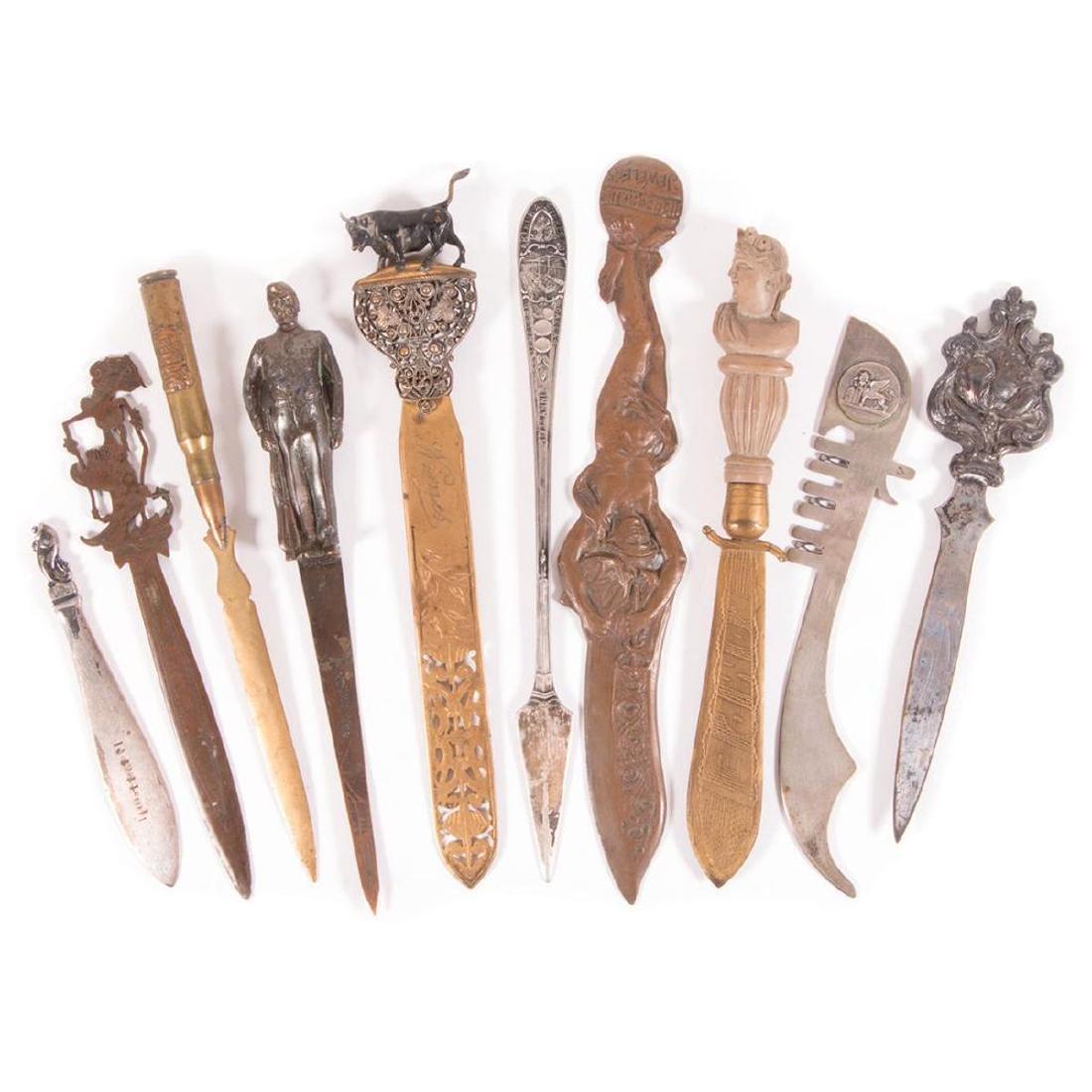 Ten Finely cast metal letter openers.: Ten finely cast early to mid century souvenir letter openers of various metals and themes.