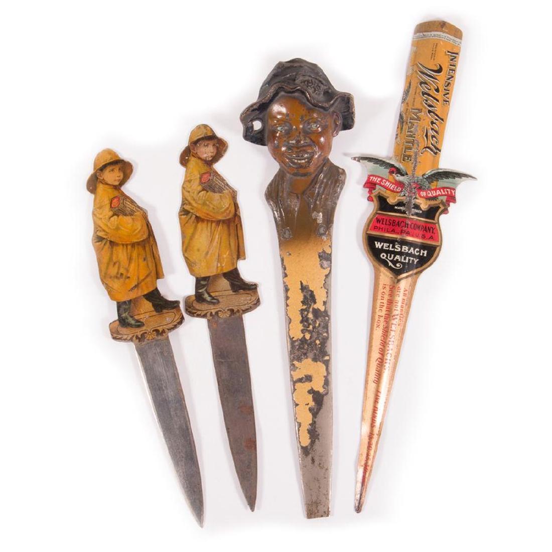 Lot of three transfer letter openers and a blackamoor: Three transfer advertisement letter openers and a cast blackamoor child opener (as shown), all early 20th century.