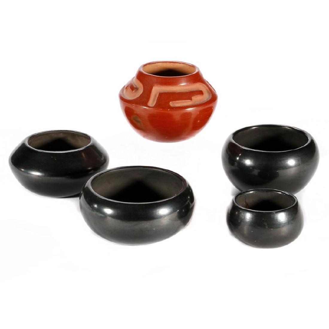 Five San Ildlefonso Vessels: A redware carved jar and a blackware bowl, both by Rose (Gonzalez); three undecorated blackware examples, by Elizabeth Tafoya, Christina Naranjo, and the smallest unsigned Diameter: 5 1/2 - 3 1/2in