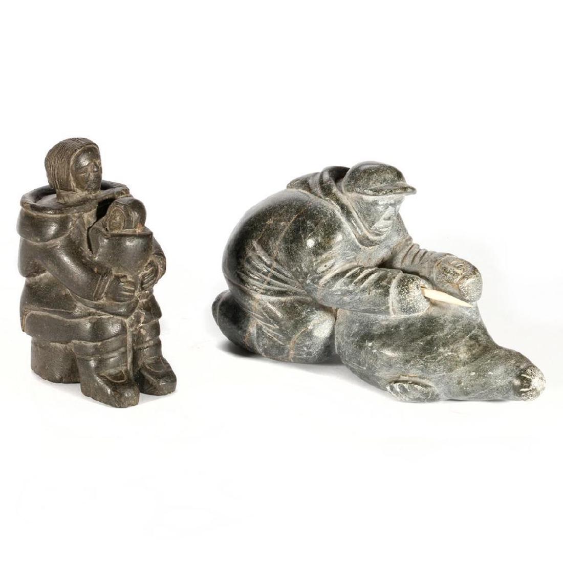 Two Inuit Stone Sculptures: Adamie Putugu, "Man Skinning a Seal"; and possibly Evie Qamugaalak, "Mother and Child" Length of first: 8 3/4in, Height of latter: 5 3/4in