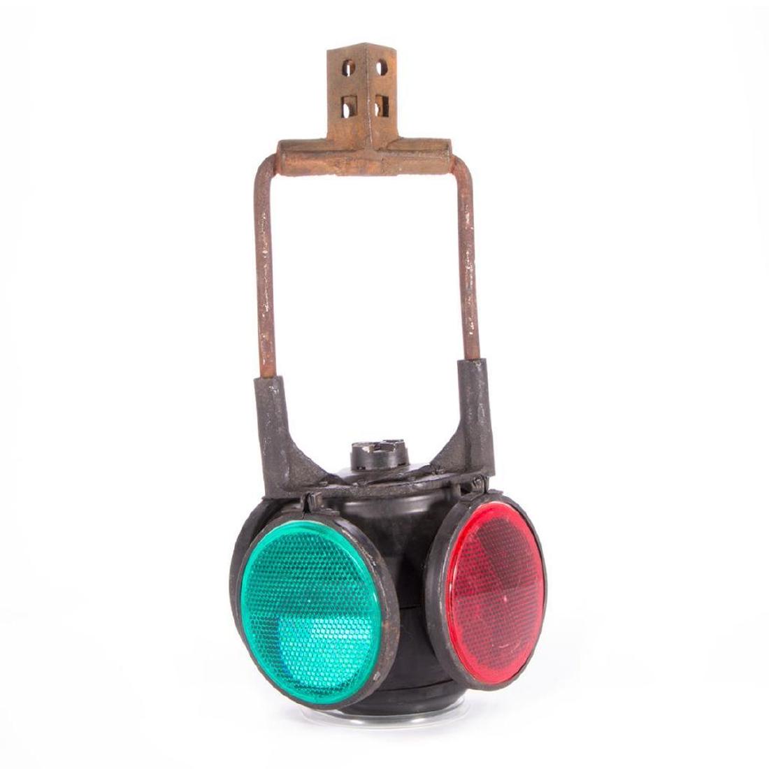 An early 20th century railroad switch light.: An early 20th century railroad switch light marked Adlake and measuring 21 inches high x 8 wide x 8 diameter.