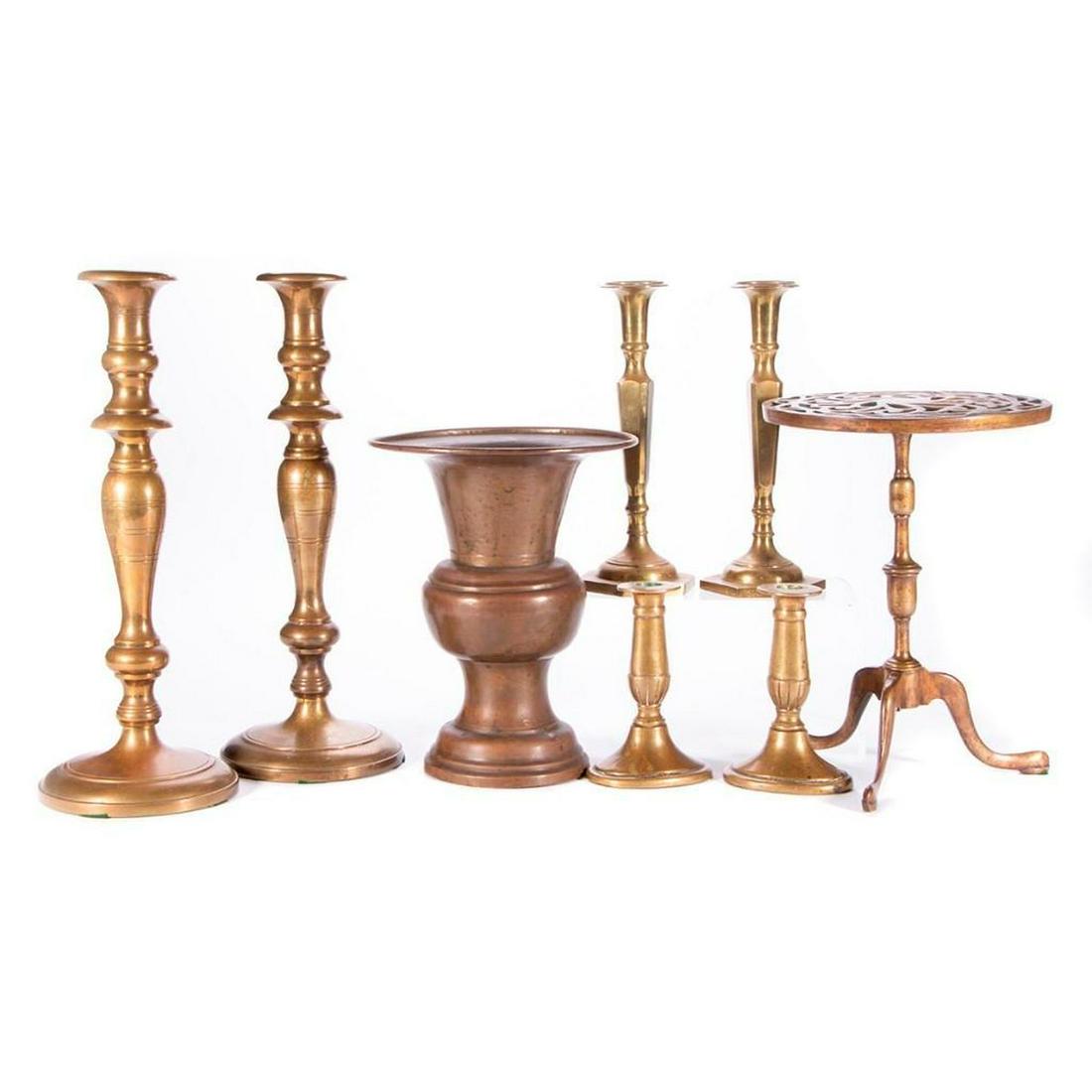 A collection of brass.: A collection of 19th century brass: three pair candlesticks, a brass raised trivet and a brass urn. Largest brass candlesticks 15 1/2 inches high. Items are sold as is. Please inquire about conditio