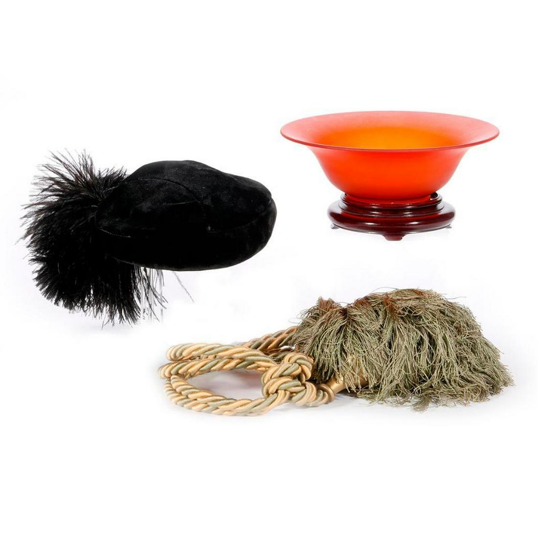 Collection of decorative objects.: An art glass bowl and stand, a poof and tassel and a beret with a "Midinette City of Paris" tag.