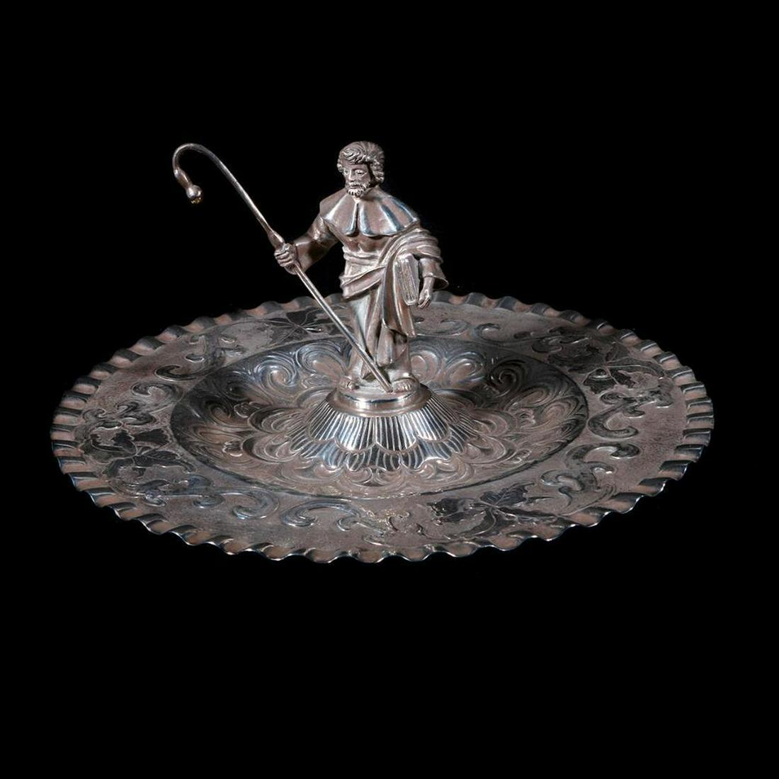 Latin American silver tray: c. 19th/20th century, with figural finial depicting an unidentified saint carrying shepherd's staff and book. 4 1/2 inches high x 9 1/2 diameter.