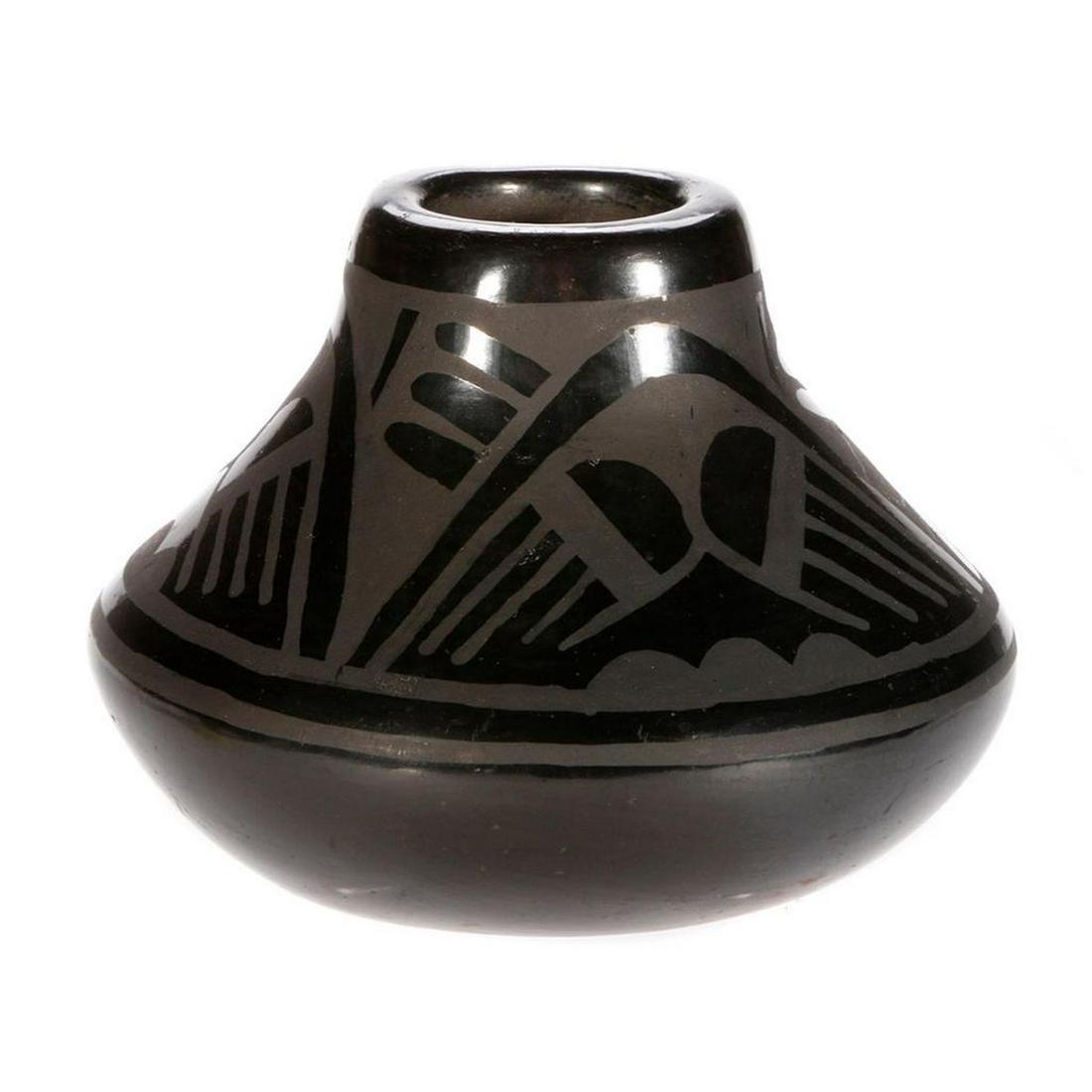 San Ildefonso vase: San Ildefonso vase, (4€x 5") by Maria Martinez and her son Adam's wife, Santana Roybal Martinez. traditional black on black design on unusually shaped vase. Made between 1943 and 1956