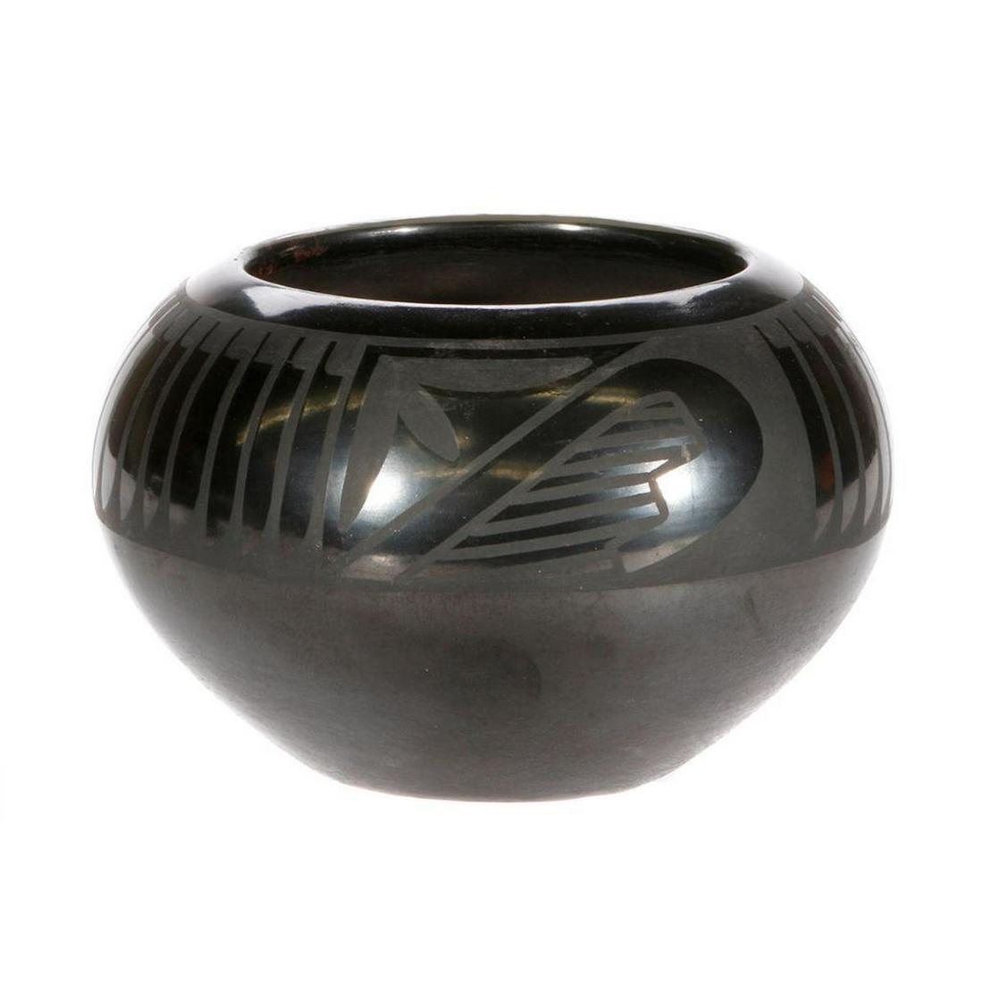 San Ildefonso bowl: San Ildefonso bowl, (4" x 6") by Maria Martinez and Popovi Da; black on black with feather and another design, made between 1956 and 1959
