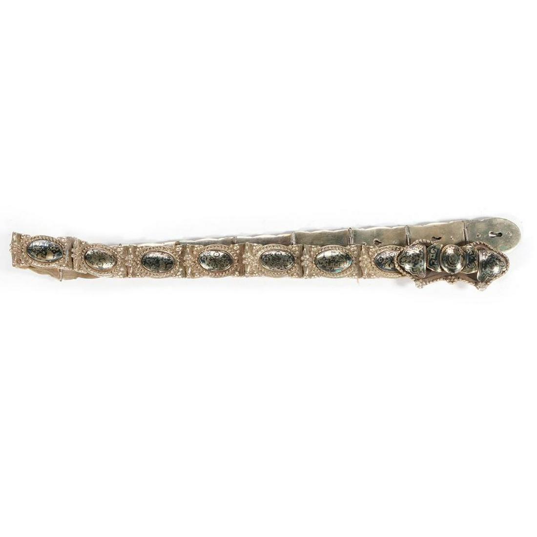 Turkish silver and enamel belt: c. first quarter 20th century, of linked buckle and panels in niello technique. Note; The belt was not tested for grade of silver nor is there any visible marks. 31 1/2 inches long.