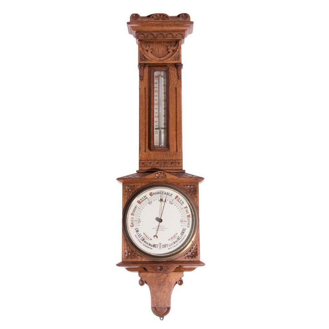A late 19th century barometer/thermometer.: A large and decorative Victorian barometer/thermometer in a carved oak case. 36 inches high x 10 wide x 3 deep.
