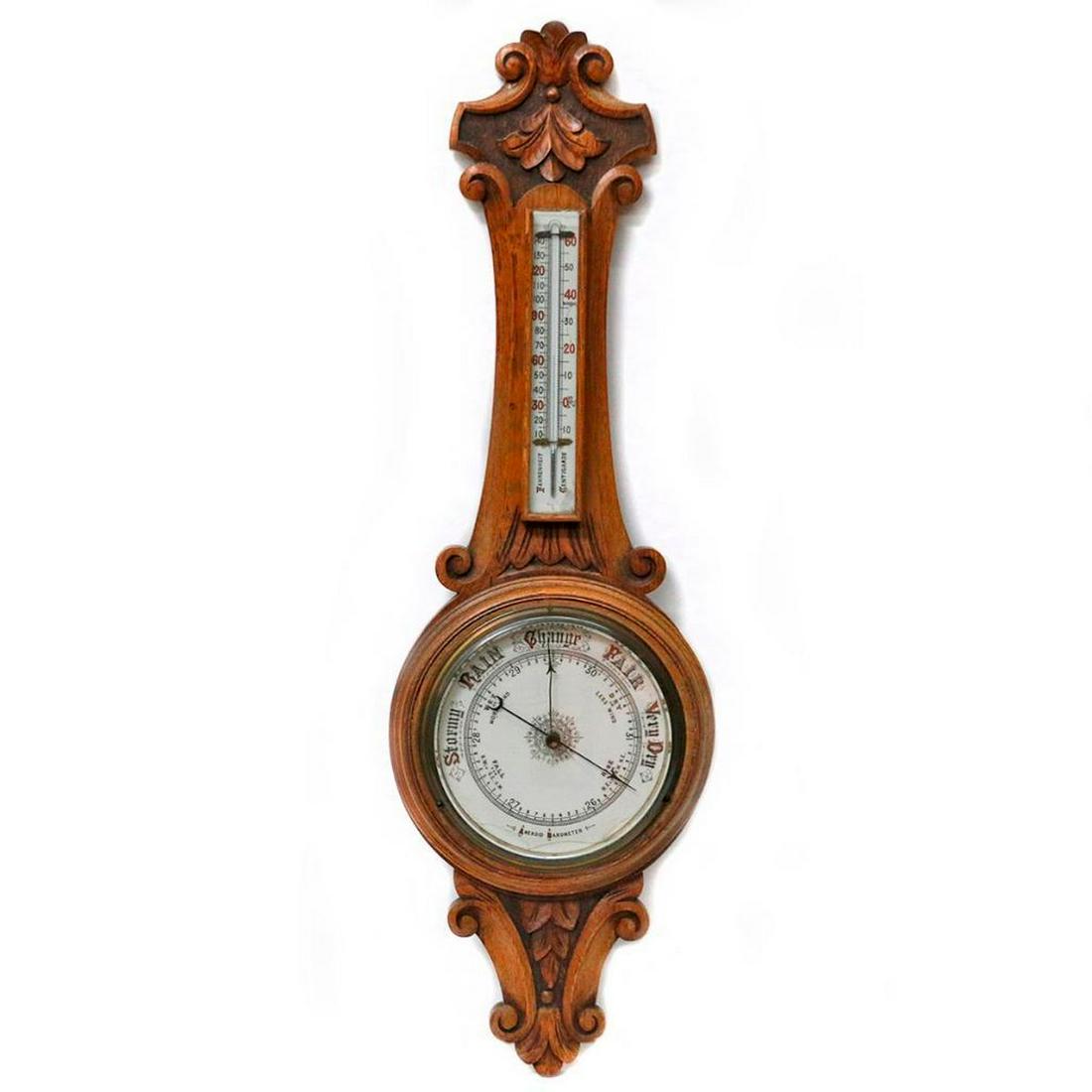 A 19th century barometer.: A large 19th century carved oak barometer/thermometer measuring 35 inches high x 11 wide.