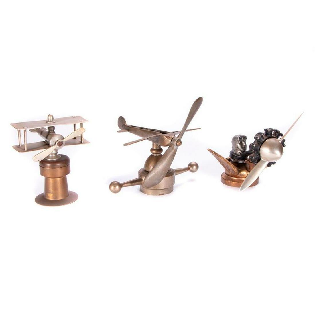 Car Mascots: BI-PLANE MASCOT ON BRASS PLINTH Height: 6 inches. BLERIOT PLANE WITH SPINNING PROPELLOR MASCOT, 1909 French, 1909 Bronze 180, black radial piston engine, distributed 1929, Western Auto Supply for 69 c