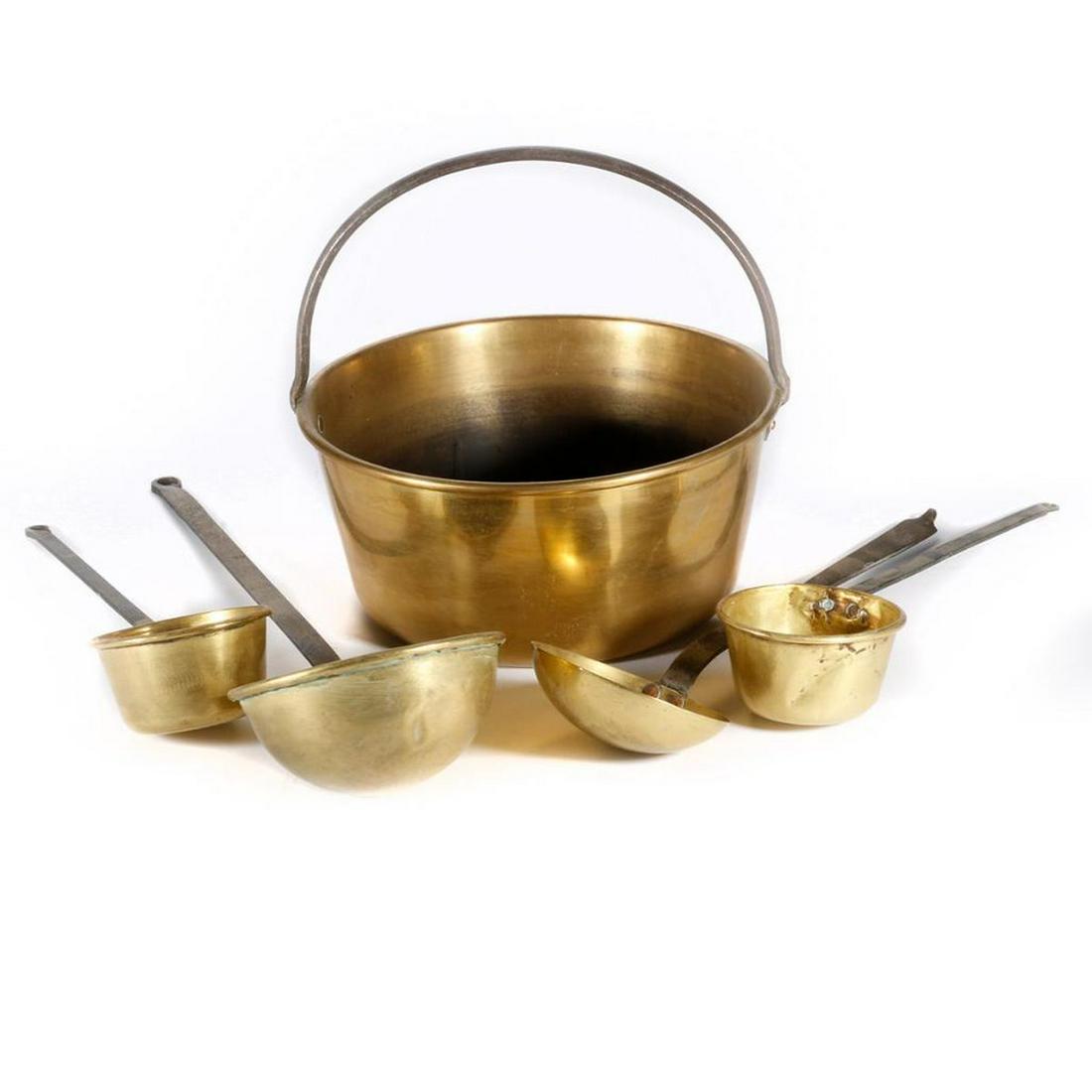 A brass fireplace pot and four ladles.: A brass and cast iron fire place pot with four ladles, pot and handle measuring 13 inches high x 14 diameter.