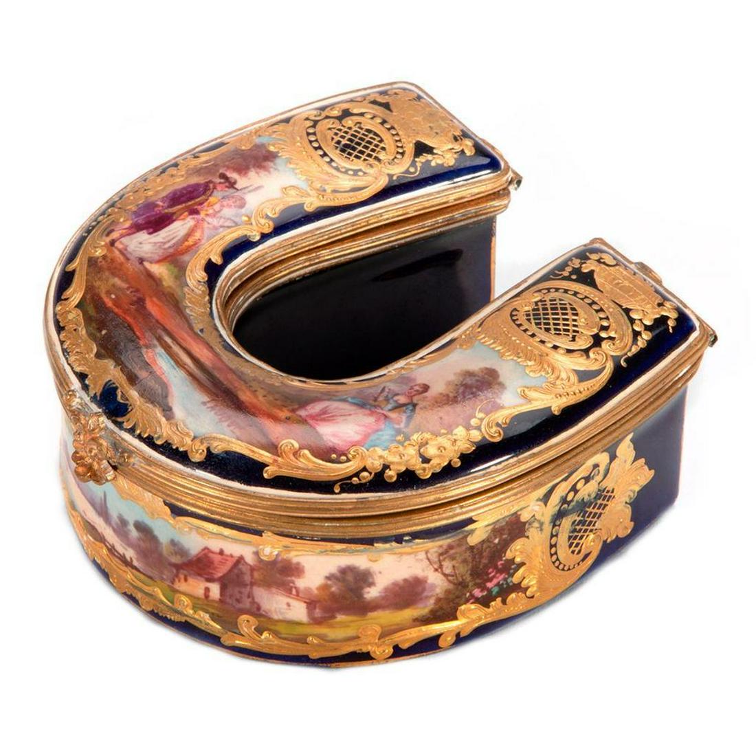 Sevre Style Horse Shoe Box: Horse Shape Box in the Style of Sevre, with finely painted scenes and heavy gilt decorations. Continental, unmarked. H-1.5" W-3.5" D-3.5" Condition: Expected Wear.