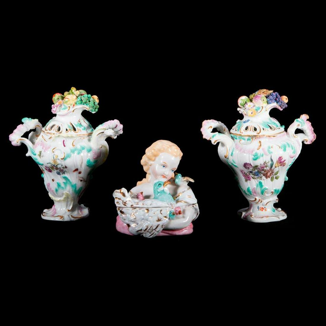 Meissen Pair of Potpourri Urns and a Continental: Pair of Rococo Style Meissen Potpourri Urns. Girl with chicken porcelain box continental. Tallest: H-6.25" Condition: repair to the base of one of the urns.