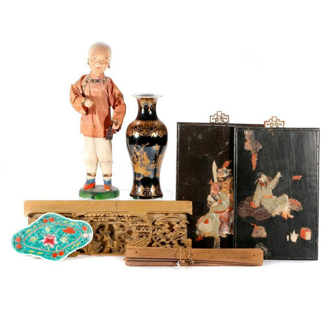 A collection of Chinese objects.: Two Chinese wood and hardstone panels (as shown), a carved and giltwood panel, a porcelain dish, a porcelain vase, a wooden doll and an Indonesian religious text on wood. The doll measures 14 inches h