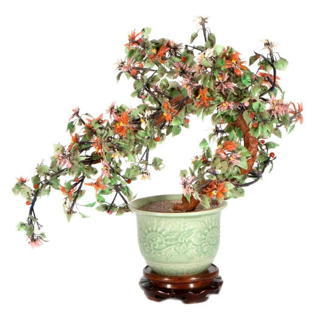 A Chinese hardstone tree.: A Chinese hardstone and celadon bonsai tree on stand measuring 21 inches high x 23 wide x9 deep.