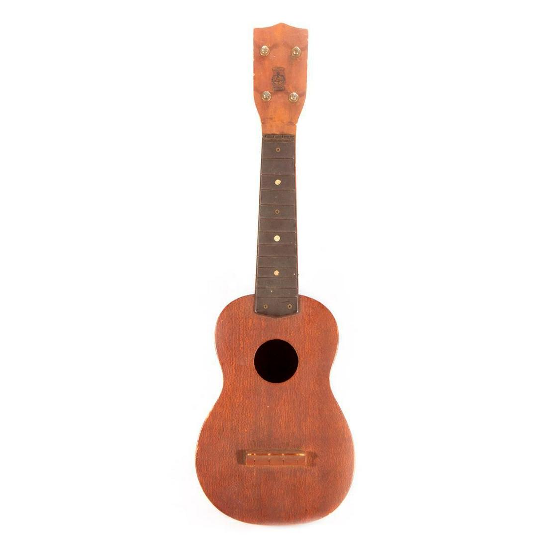 A vintage Hawaiian ukukele.: A vintage Hawaiian ukulele measuring 21 inches high x 6 1/2 wide x 2 3/4 deep.