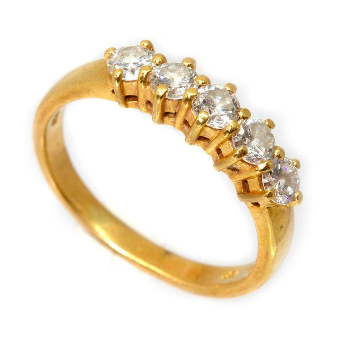 Moissanite and 18k gold band: weighing approximately: 4.7 grams; size: 7 1/2 (bent)