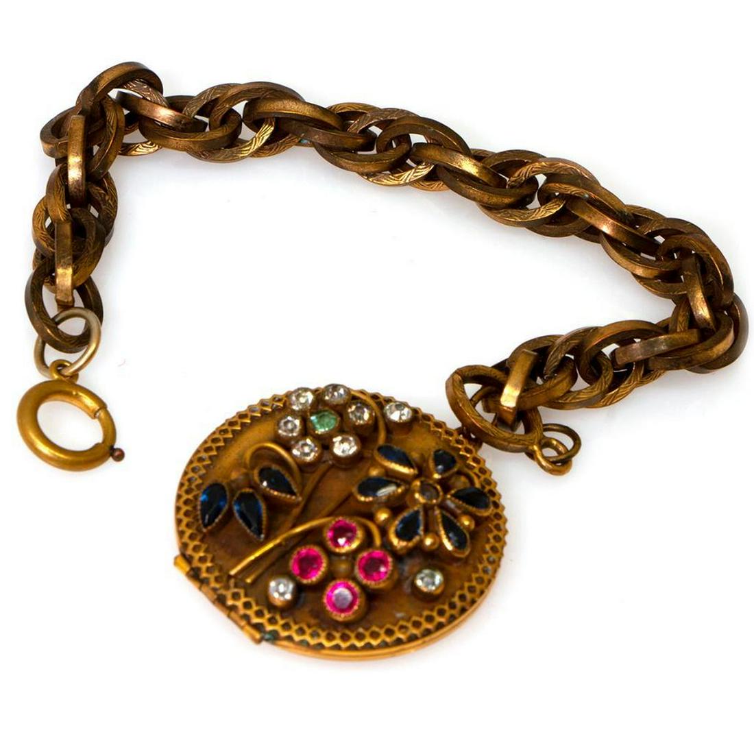 Sandor vintage rhinestone charm bracelet: suspending a round locket; length: 7 3/4in.