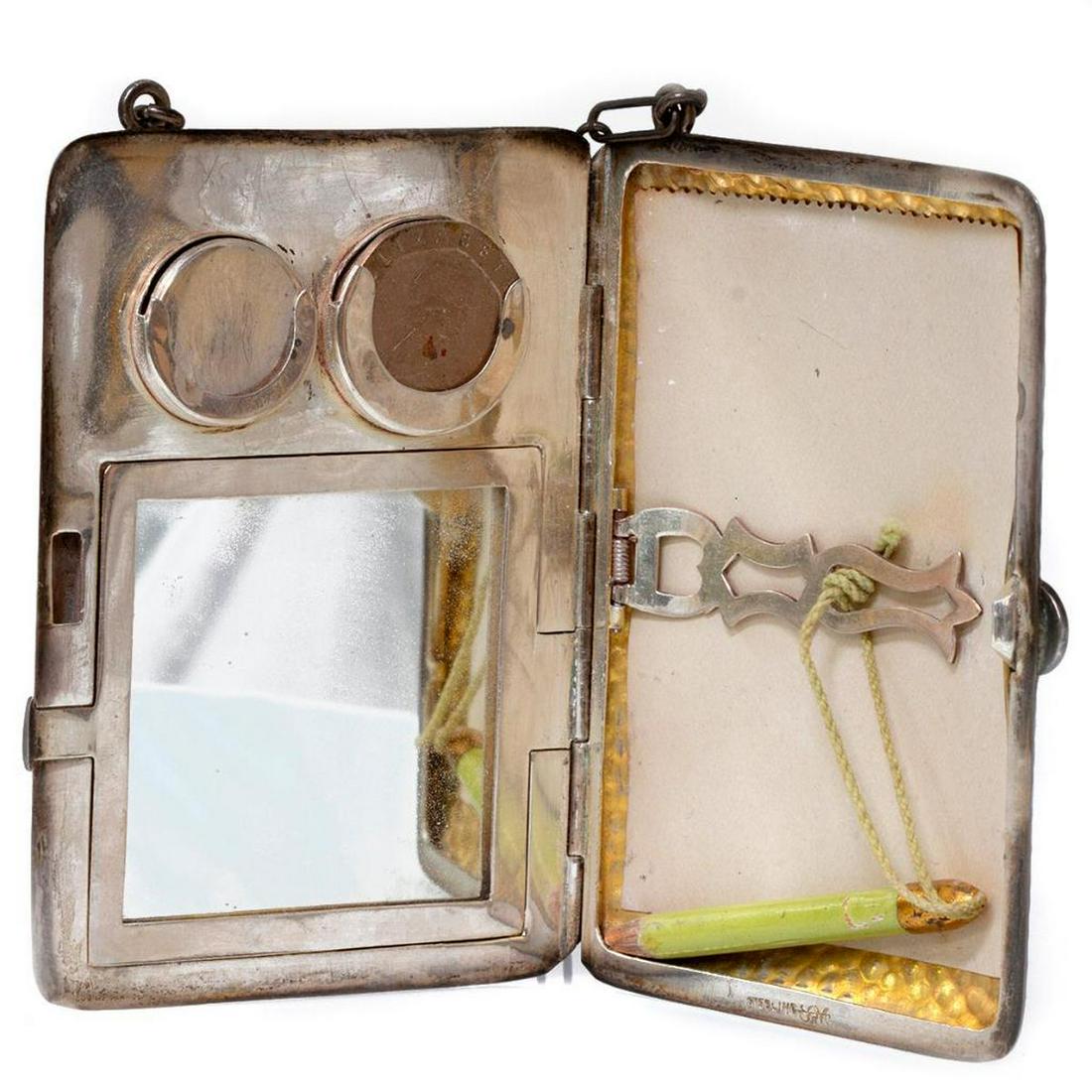 Antique sterling silver minaudiere: opens to hinged mirror with compartment, bone writing slate, 2 coin holders, hinged cigarette arm; full dimensions: 9 x 2 1/4 x 5/8in.