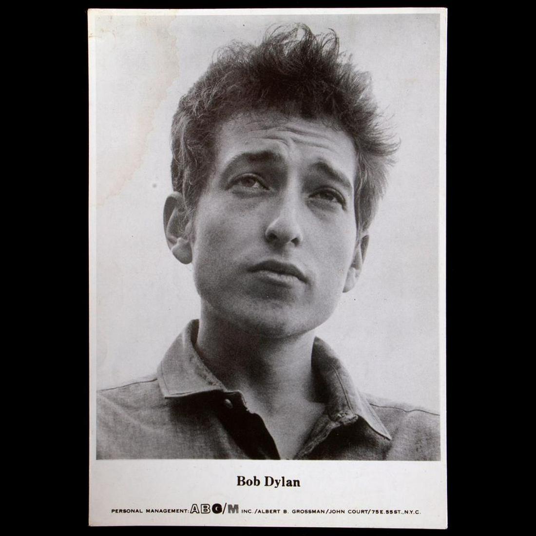 Bob Dylan promo photo.: A 7 3/4" x 5 1/2" Bob Dylan promo photo for The Times They Are A-Changin' poster reconfigured from the photo for the album. Condition: Good to fair, water stain on upper left.