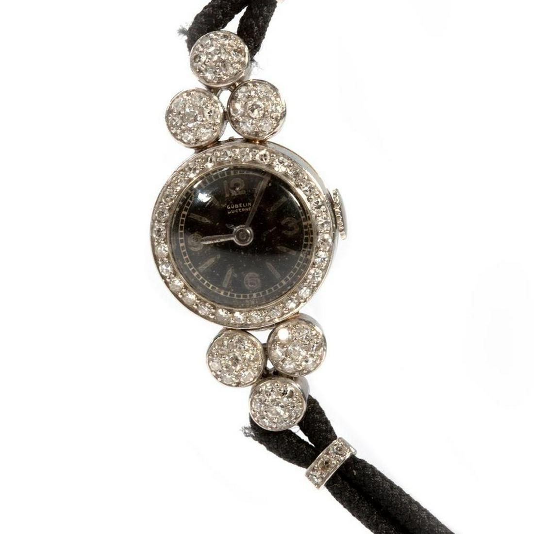 Gubelin diamond, platinum and cord ladies wristwatch: circa 1950s, 17j, 3 adjustments, with black dial, the Lucerne case and lugs set with 78 single-cut diamonds, and weighing an estimated 1.00ct, G-H-I/VS; with later added 18k white gold clasp; diameter