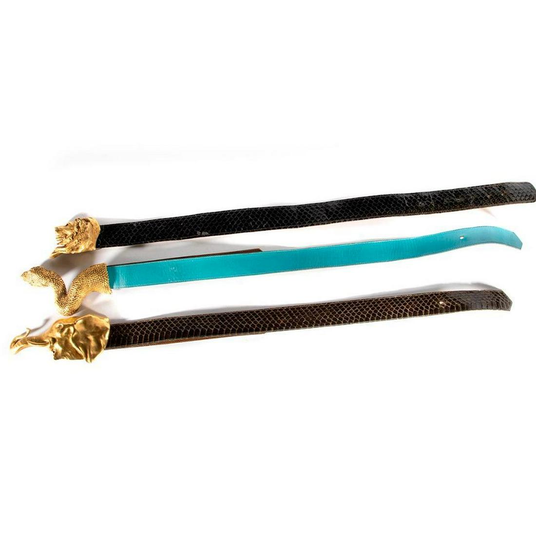 Three belts & brass belt buckles by C. Ross: in the form of: a snake, c. 1980, 6 1/2 x 3in.; an elephant, c.1980, 7 x 3in. (missing one eye); and a lion, c. 1976, 4 x 2/12in.; lengths adjustable