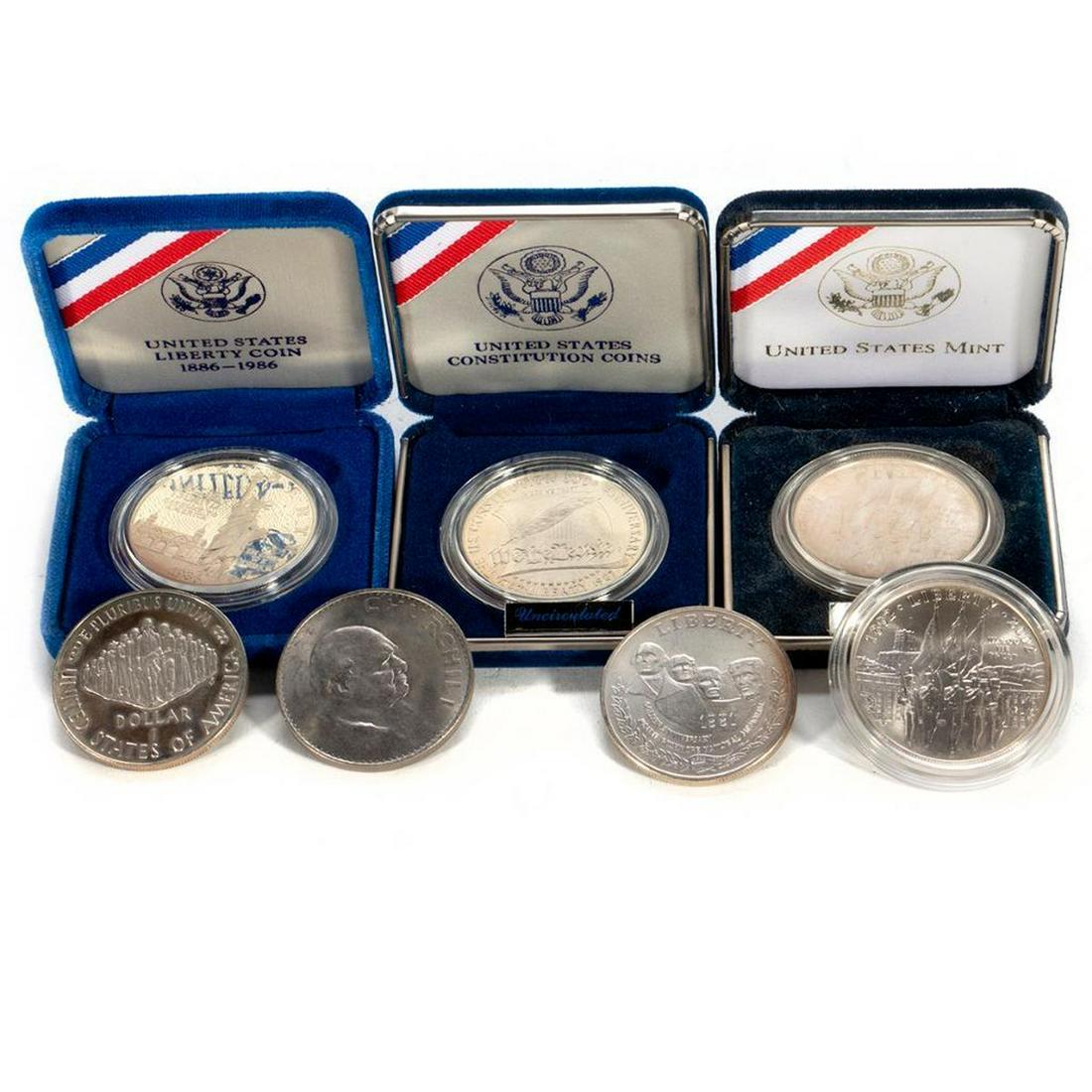 1986 Liberty Silver Dollar Coin, 2002 West Point Silver: (1) 1986 Liberty Silver Dollar Coin, (2) 2002 West Point Silver Dollar Coin, (2) 1987 Constitution Silver Dollar Coin, (1) 1991 Mount Rushmore Silver Dollar, (1) 1965 Churchill Coin.