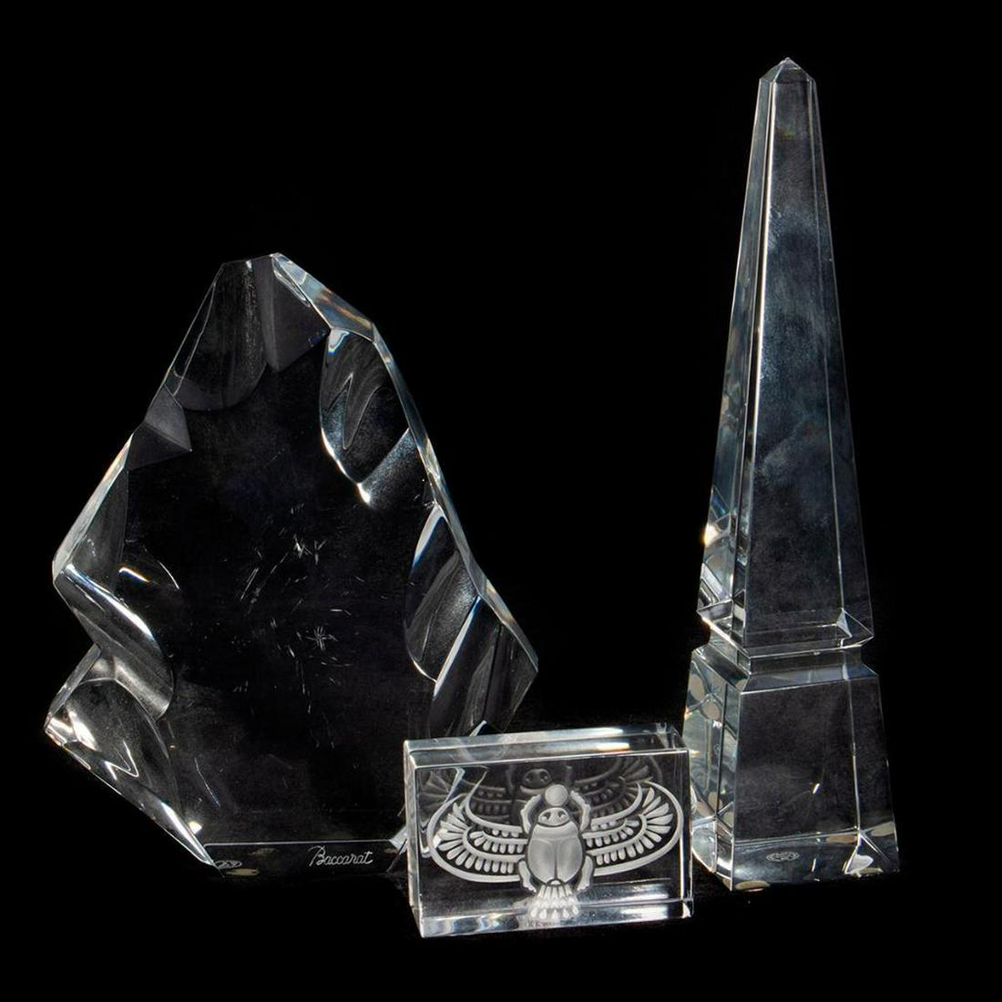 Baccarat Crystal Decorations: Including an obelisk, a scarabengravedpaperweight, and iceberg. greatest height 10in. condition: minor scratches to iceberg.