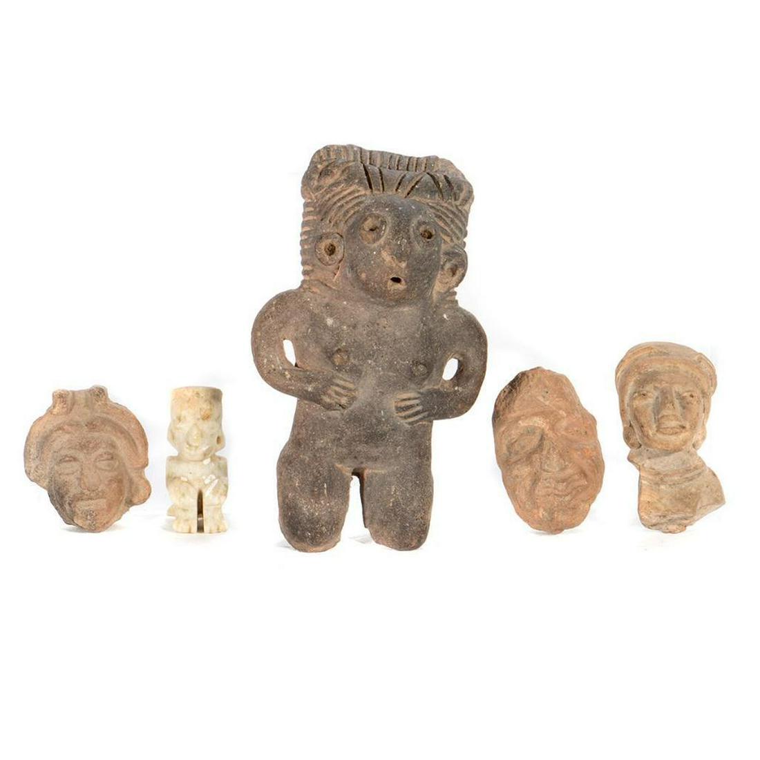 Collection of Vera Cruz Stone Figures.: Including a standing figure, a seated figure, and three busts. Greatest height 5in. Condition: Weathered, as expected for age.