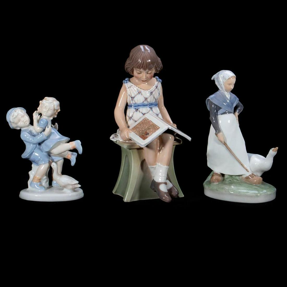 Copenhagen Porcelain Figures: Including a figure of a goose herd, children playing, and a girl reading. Greatest height 9in. Condition: All in very good condition