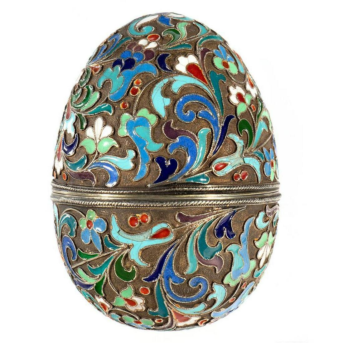 Russian Enamel Silver Egg: An early 20th-century Russian Enamel Silver Egg covered with floral patterns. The egg is gilded inside. Russian Hallmarks. Size: 3 in. Overall condition good.