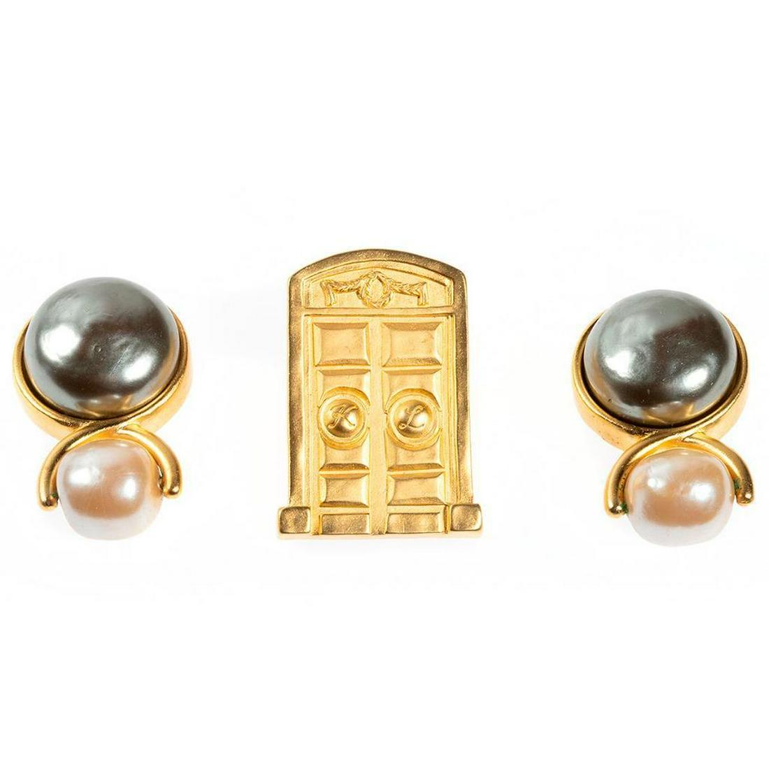 Karl Lagerfeld brooch and clip earrings: gold tone costume jewelry; brooch measures 1 1/2 x 1 1/8in., earring length: 1 1/2in.