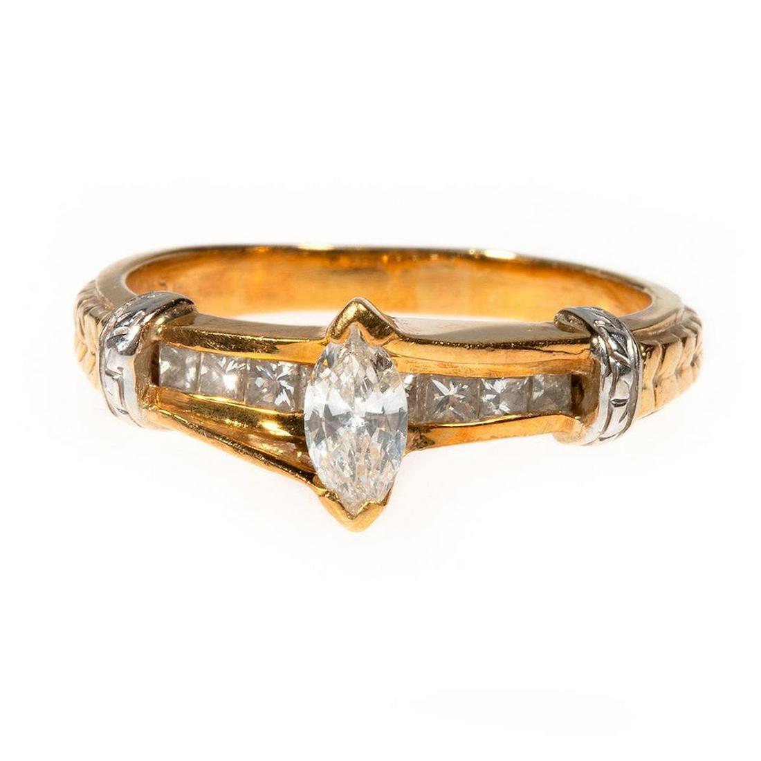 Diamond and 18k bi-color gold ring: centering a marquise-cut diamond weighing an estimated 0.23ct, G-H/SI-Imp, channel-set beneath with 8 princess-cut diamonds; estimated total diamond weight: 0.55ct.; weighing 5.0 grams; size: 6 3/4