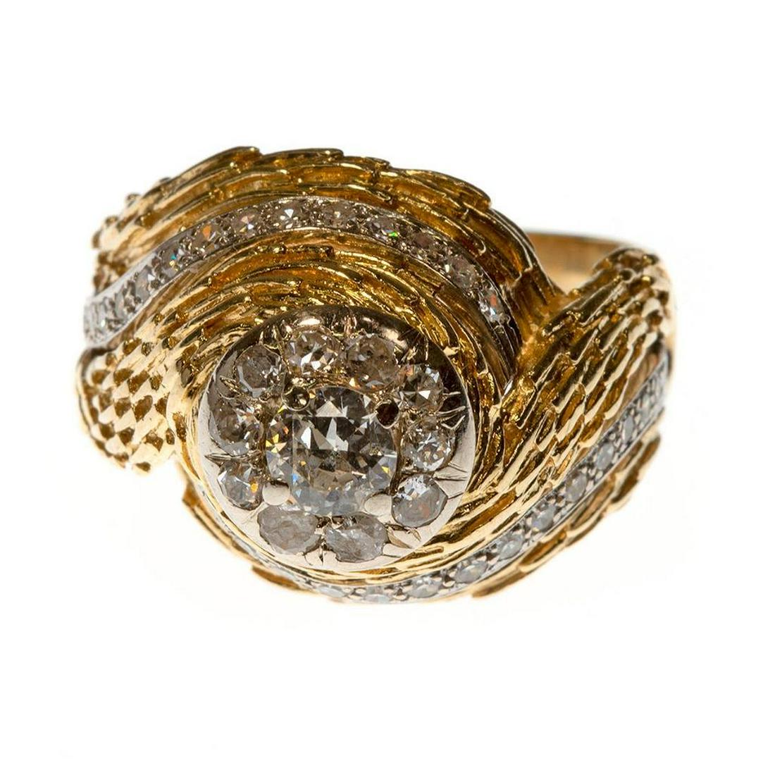 Diamond and 18k gold ring, La Triomphe: the textured, high-domed, spiral ring centering a transitional round brilliant-cut diamond weighing approximately 0.45ct, surround by and spiraled with additional round brilliant and single-cut diamon