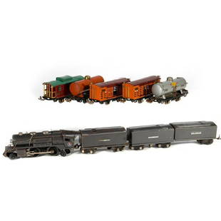 Lionel train cars: Lionel 259E Locomotive with whistling tender. Extra whistling tender and a 1689T body with one truck and coupler, missing the other truck. 806 Stock Car, 806 Stock Car, 804 Sunoco Tank Car, 804
