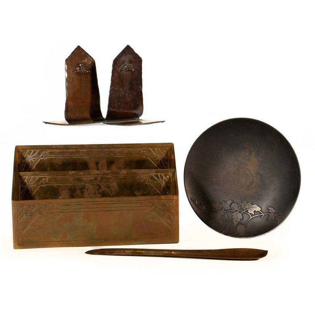 Hammered Copper and Brass Desk Furnishings: Including a pair of Craftsman Studios bookends, an Art Metal Craft letter holder, a letter opener (indistinctly marked), and sterling on bronze plate. Greatest height 4 1/2in (12cm) Condition: Goo