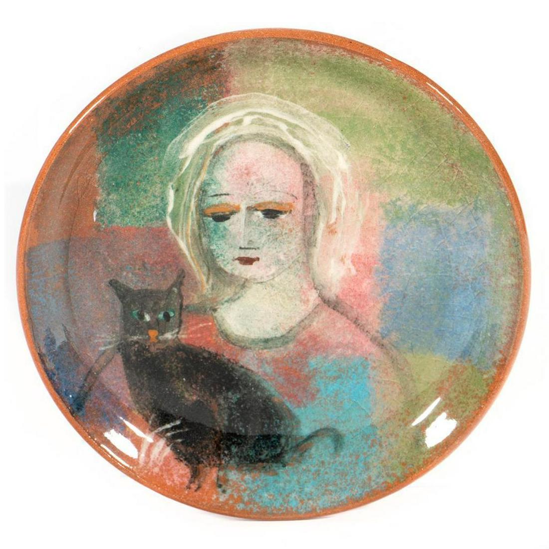 Polia Pillin Mid-Century Plate: Polia Pillin (1909-1992) Polish-American The small plate decorated with a woman and cat. Signed under glaze on base. 5 1/2in (14cm) d. Condition: Minor glaze blister on surface and base, otherwise g