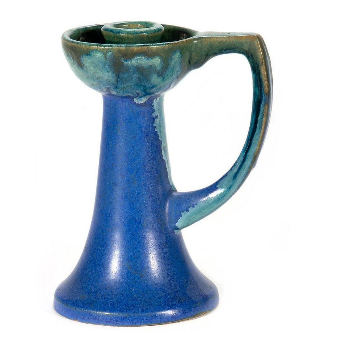 Fulper Pottery Candlestick: The dished candle cup on tapering base with wide handle. Incilsed and paper label on base. 6 3/4in. (17cm) h. Condition: Very good.
