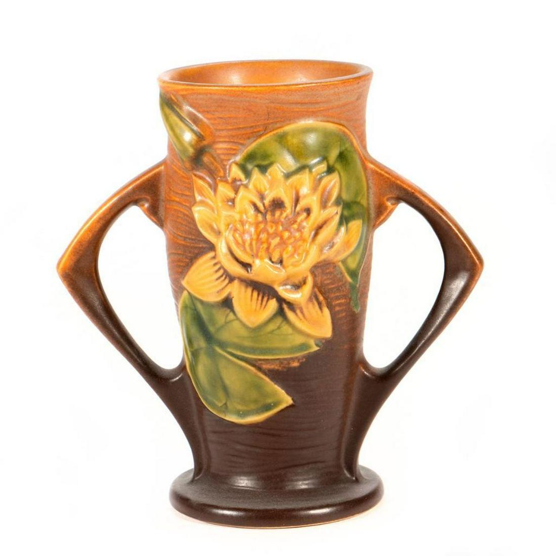 Roseville Pottery Vase: Decorated with raised sunflowers. Circa 1935 raised mark on bottom. 6 1/2in. (16cm) h. Condition: Very good.