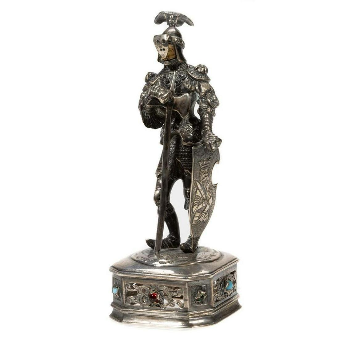 German Medieval-Style Sterling Silver Figure: German Medieval-Style Sterling Figure. Having carved bone heads and standing on a square base with chamfered corners, reticulated designs to the sides, and faux stone cabochons. Marked Sterling 925
