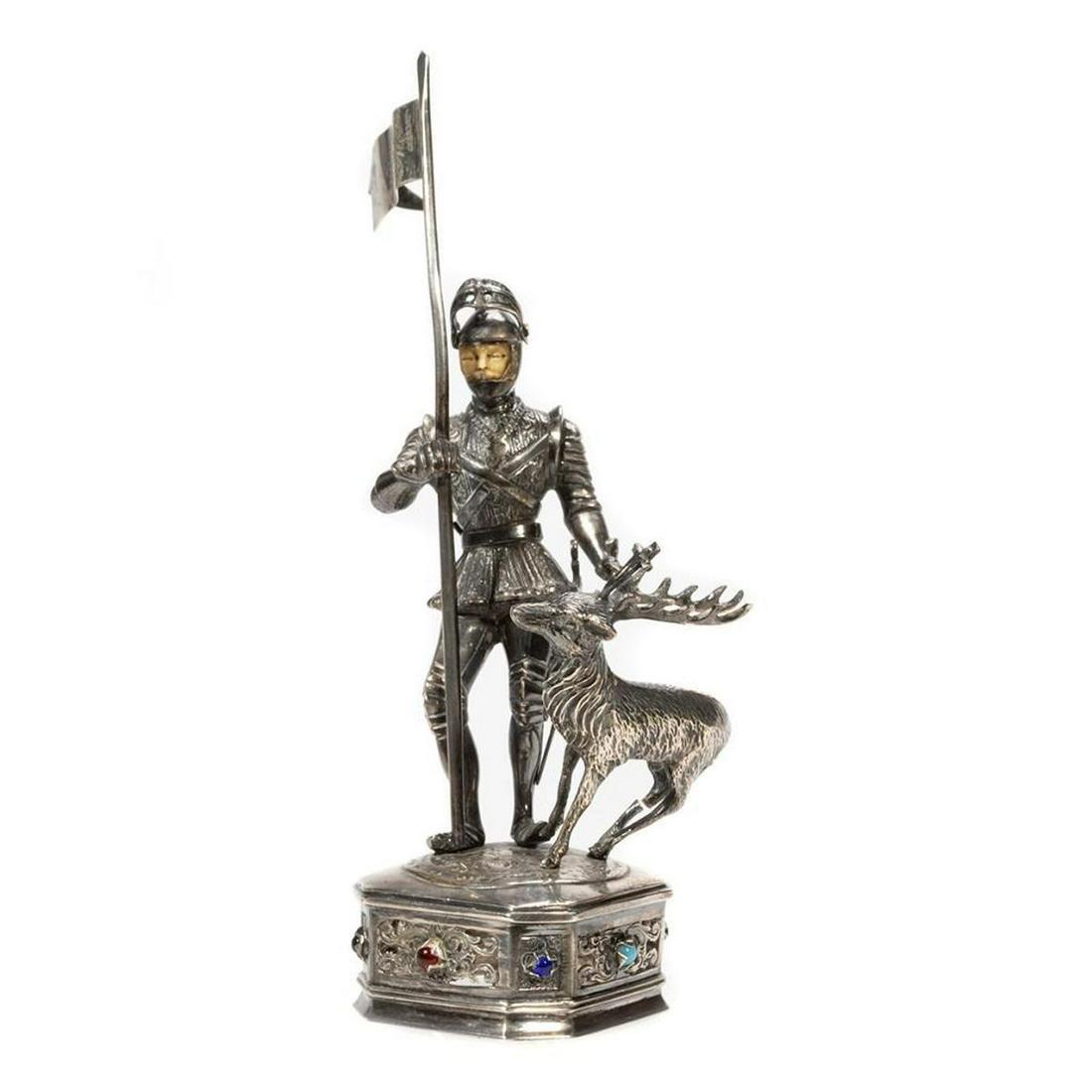 German Medieval-Style Sterling Silver Figure: German Medieval-Style Sterling Silver Figure. Having carved bone heads and standing on a square base with chamfered corners, reticulated designs to the sides, and faux stone cabochons. Marked Sterli