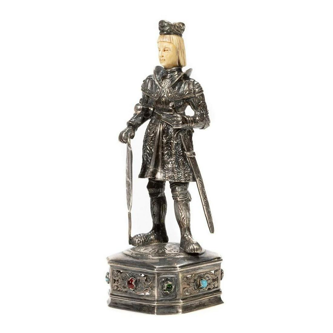 German Medieval-Style Sterling Silver Figure: German Medieval-Style Sterling Silver Figure. Having carved bone heads and standing on a square base with chamfered corners, reticulated designs to the sides, and faux stone cabochons. Marked Sterli
