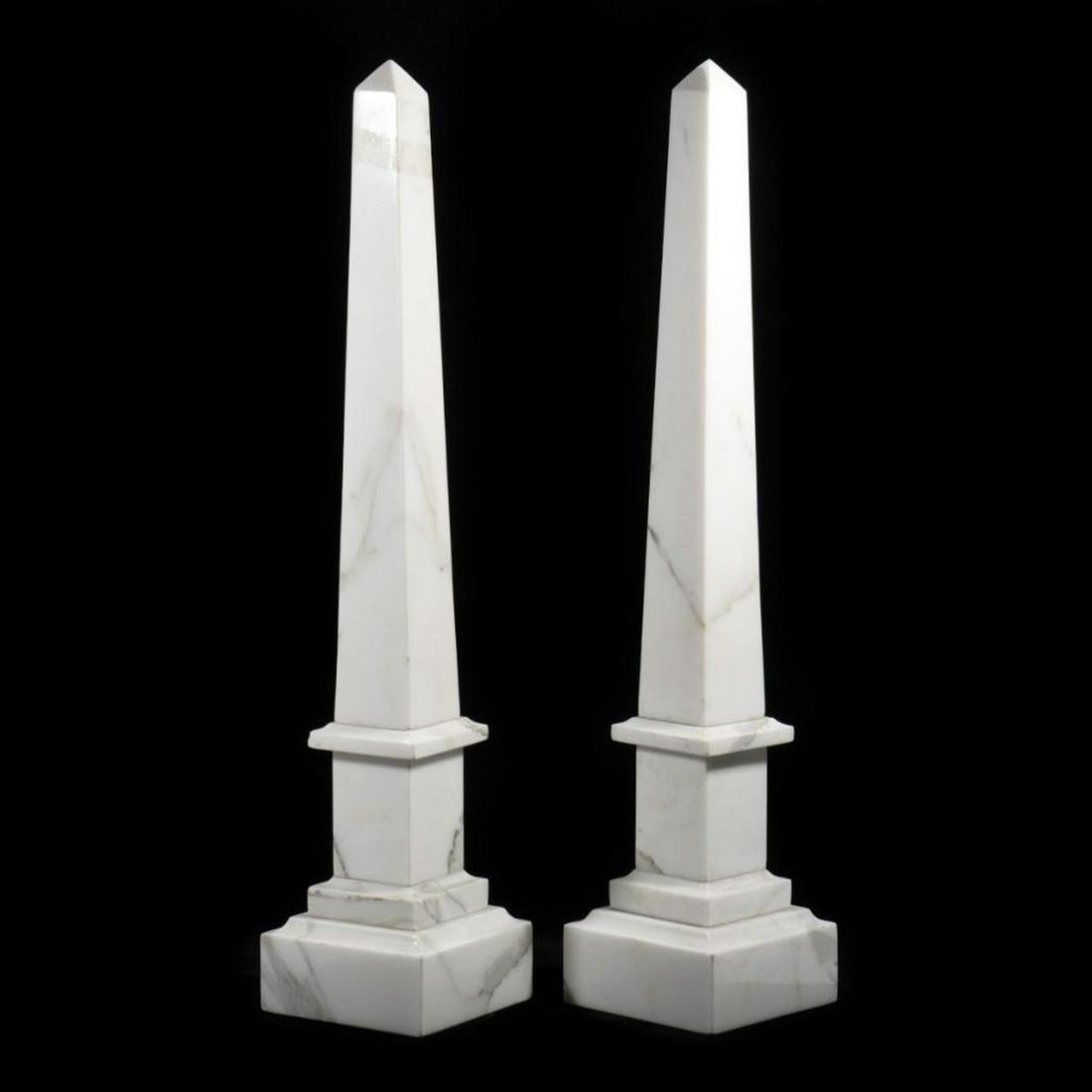 Pair of Neoclassical Style Marble Obelisks: Each rising from a stepped base. 28in. (71cm) Condition: Minor chip to base of one, adhesive remnant on one.