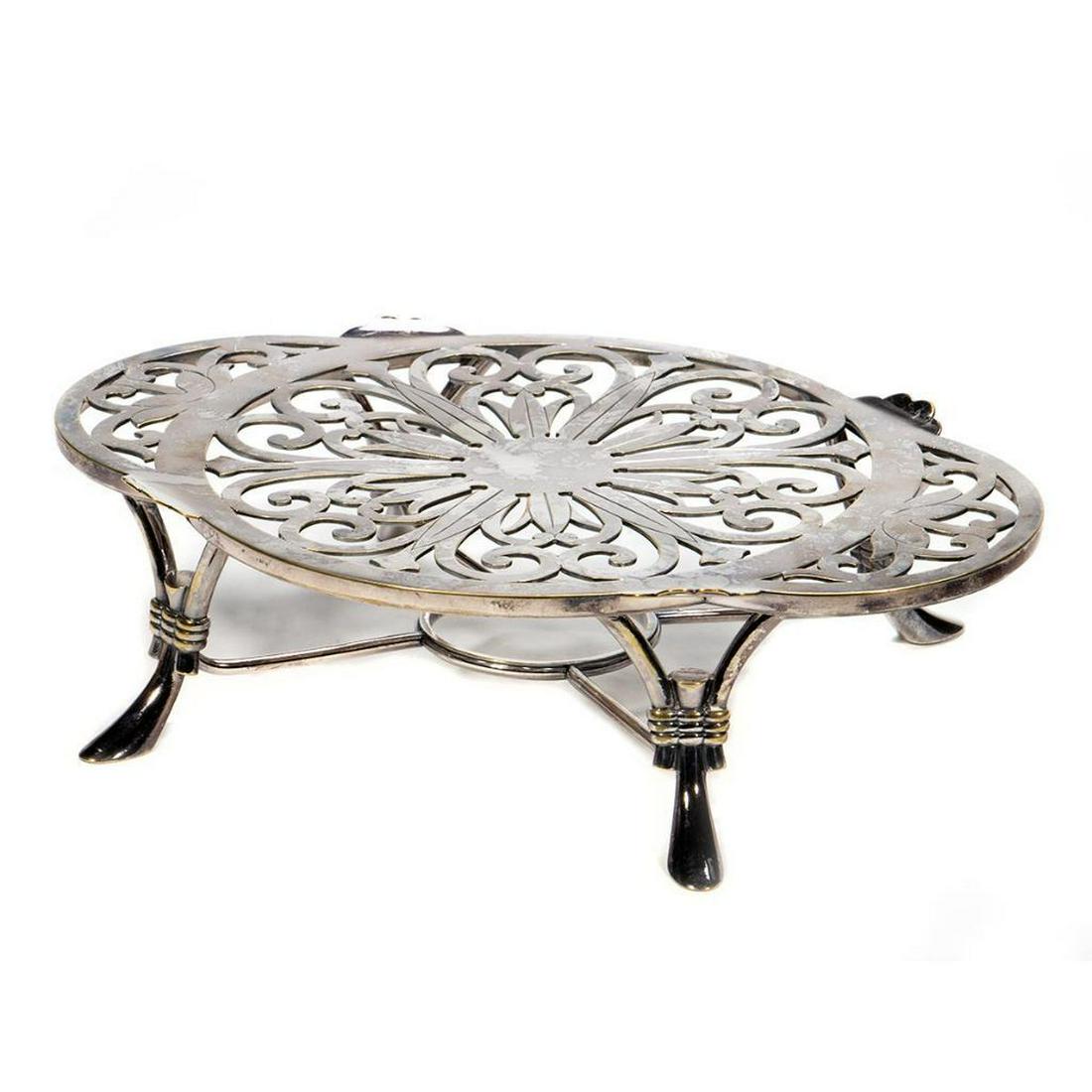Christofle Silver Plate Trivet: In the Rococo style on tapering legs.3 1/2in. (9cm) h. 13 1/2in. 34cm) l. Condition: Very good with some tarnish